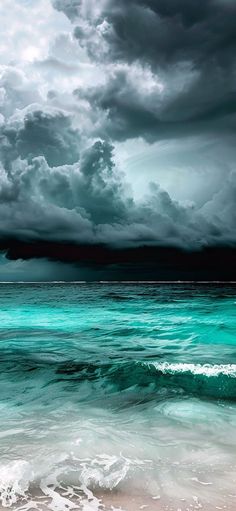 an ocean scene with dark clouds and blue water