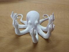 an octopus figurine sitting on top of a wooden table