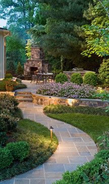 an outdoor patio with stone steps and landscaping