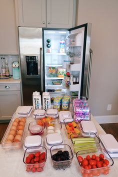 an open refrigerator with food on the counter