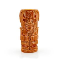 an orange tiki statue on a white background