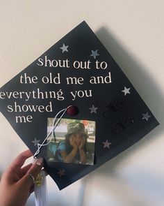 someone is holding up a graduation cap that says, shut out to the old me and everything you showed me