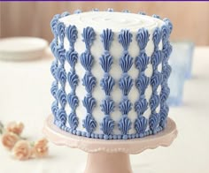 a blue and white cake sitting on top of a table