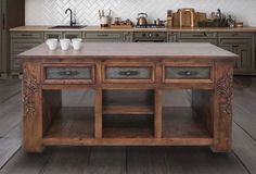 a large kitchen island with drawers in the center