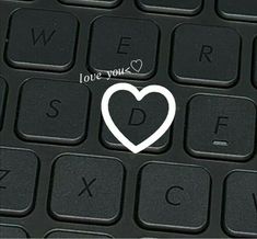 a computer keyboard with a white heart on it's left side and the words love you