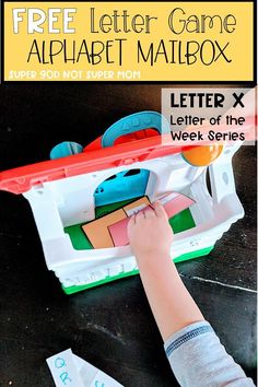 a child is playing with an alphabet mailbox