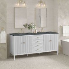 a white bathroom with two sinks and mirrors on the wall next to a bathtub