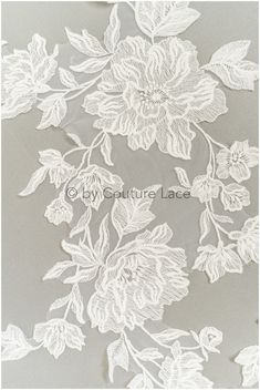 white lace with flowers and leaves on grey background, suitable for use in wedding dress or bridal gown