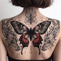 a woman's back with a butterfly tattoo on it