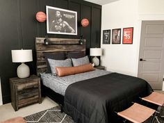 a bed room with a neatly made bed and two basketballs on the wall above it