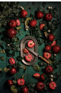 an apple peeler surrounded by apples and leaves