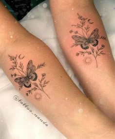 two women with tattoos on their legs sitting next to each other, both have butterflies and flowers