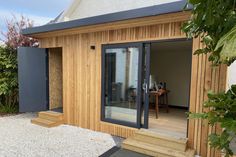 a small wooden building with sliding glass doors