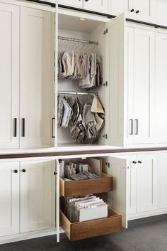 an open cabinet with files and folders on the bottom shelf in front of it