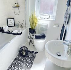 a white bathroom with black and white decor