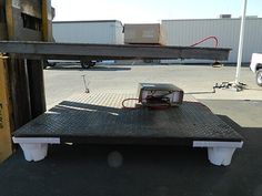 the back end of a truck with an electronic device on it's flatbed