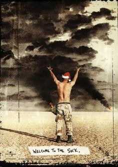 a man standing in the middle of a desert under a cloudy sky with his arms up