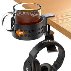 the headphones are next to a cup of tea