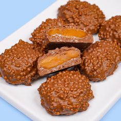 chocolate covered donuts on a plate with sprinkles and orange peels