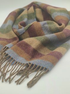 Irish Soft Lambswool scarf - 100% Pure New Wool - blue/bronze/burgundy/beige/green stripes - very soft - unisex - HANDMADE IN IRELAND Keep warm in style this season with our supersoft lambswool scarf. Woven in Ireland in traditional country checks with fringed trim. Lambswool is the highest quality sheep's wool. Along with being a naturally insulating, breathable and hypoallergenic textile, it's beautifully soft. Not to be confused with sheep's wool, lambswool is the wool from the first shearing Ruana Wrap, Baby Sheep, Green Scarf, Fashion Aesthetics, Craft Business, Sheep Wool, Green Stripes, Keep Warm, Scarf Wrap