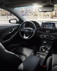 the interior of a car with dashboard, steering wheel and infotains on display