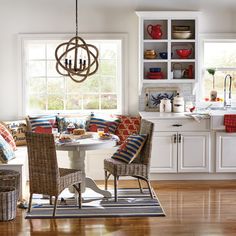 an open kitchen and dining room with white cabinets