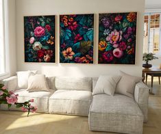 a living room with three paintings on the wall