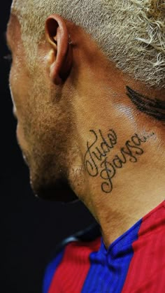 the back of a man's neck with his name tattooed in black ink on it