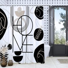 a black and white shower curtain with an abstract design in the middle, next to a potted plant