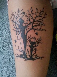 a person with a tree tattoo on their leg