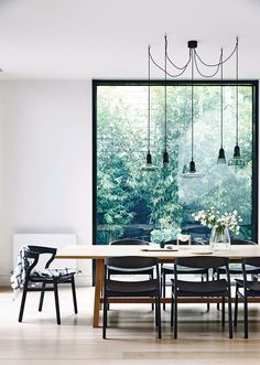 a table and chairs in front of a window with the words house and garden on it