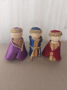 three small wine corks with rope wrapped around them