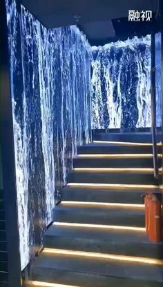 the stairs are covered with icicles and water flowing from them to the wall behind them