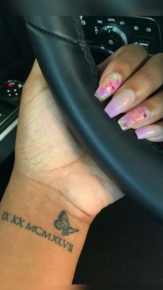 a woman's hand with a butterfly tattoo on her wrist and the words dixie mcm