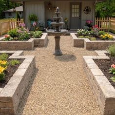 an outdoor garden with gravel and stone edgings, including a fountain in the center