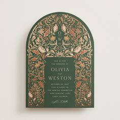 a green and gold wedding card with an ornate design on the front, featuring leaves and flowers