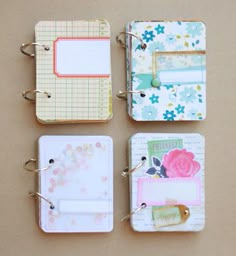 four small notebooks are lined up on a table