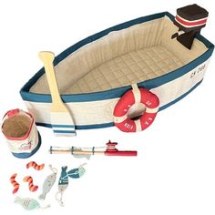 an inflatable boat with toys and accessories on the side, including a sand pail