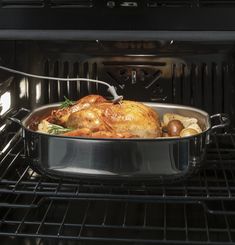 a roasting pan filled with chicken in an oven