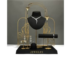 a jewelry display with black and gold accessories