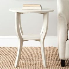 a white end table with a book on top