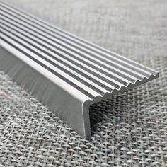 an image of a metal strip that is laying on the ground in front of some fabric