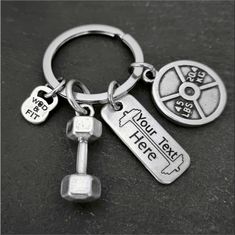 a keychain that has two keys attached to it with the words now take here