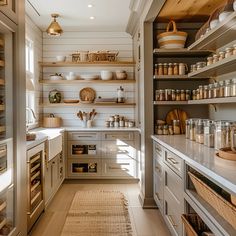 a kitchen filled with lots of open shelves