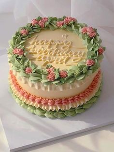 a three layer cake decorated with flowers and the words happy birthday