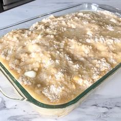 a casserole dish is sitting on a marble counter top, ready to be baked