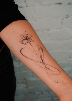 a woman's arm with a tattoo on it and a flower in the middle