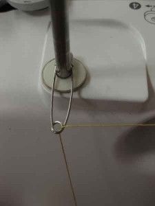 the sewing needle is being used to sew something on it's machine,