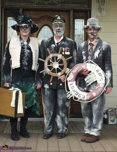 three people dressed in costumes standing on the front porch