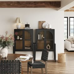 a living room filled with furniture and a book shelf on top of a hard wood floor